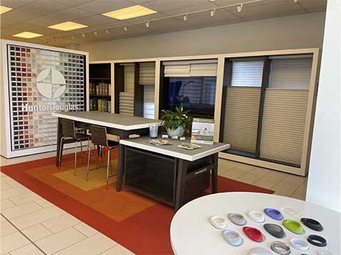 store interior with a desk surrounded by window covering samples