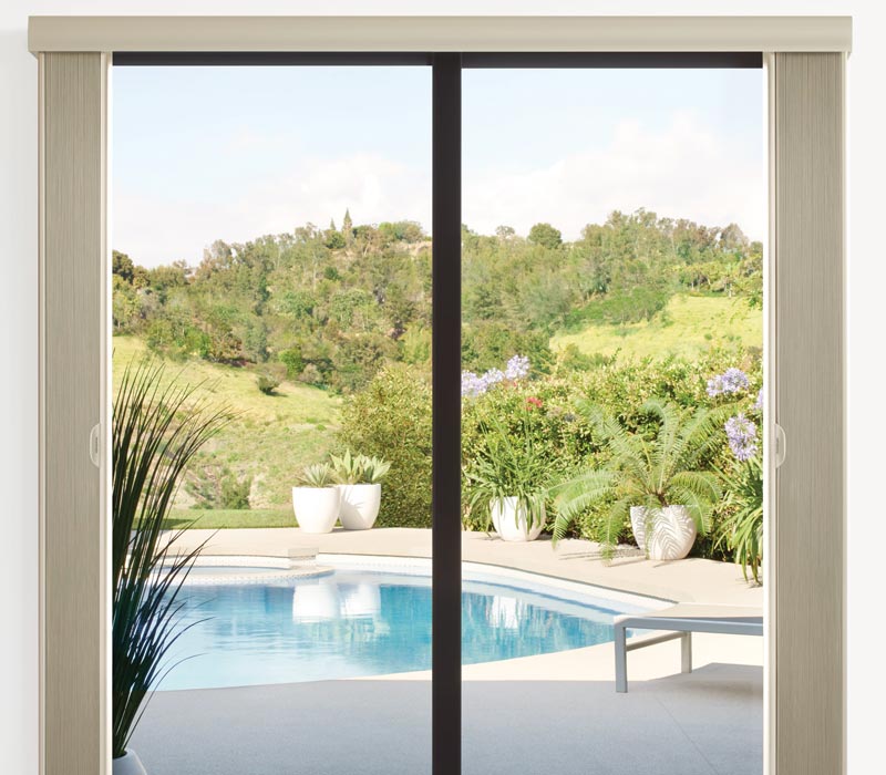 Vertical cellular shades installed on sliding glass door